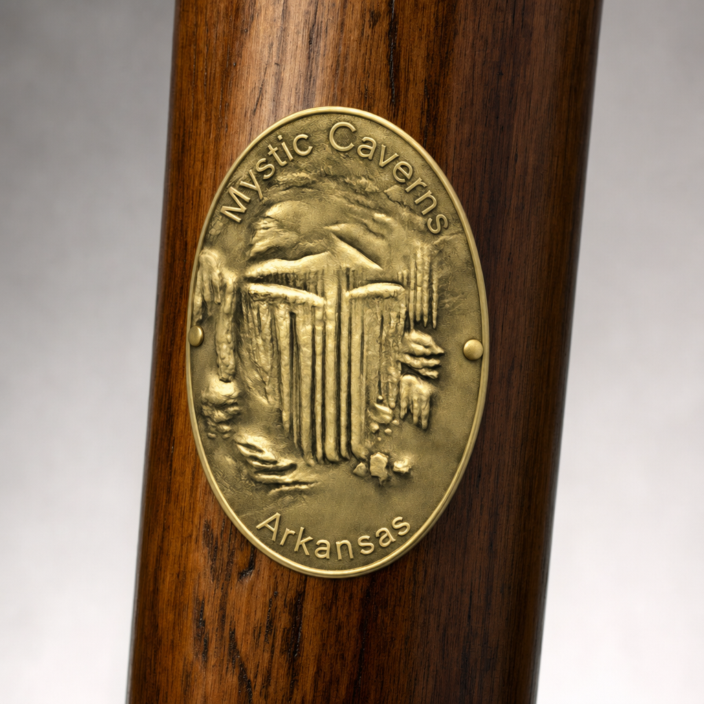 Mystic Caverns hiking stick medallion installed on a wooden hiking staff