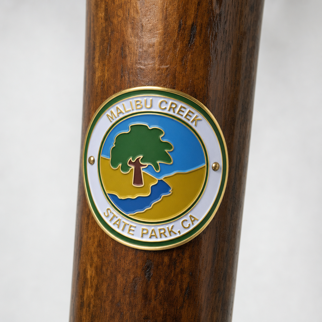 Malibu Creek State Park hiking stick medallion installed on a wooden hiking staff