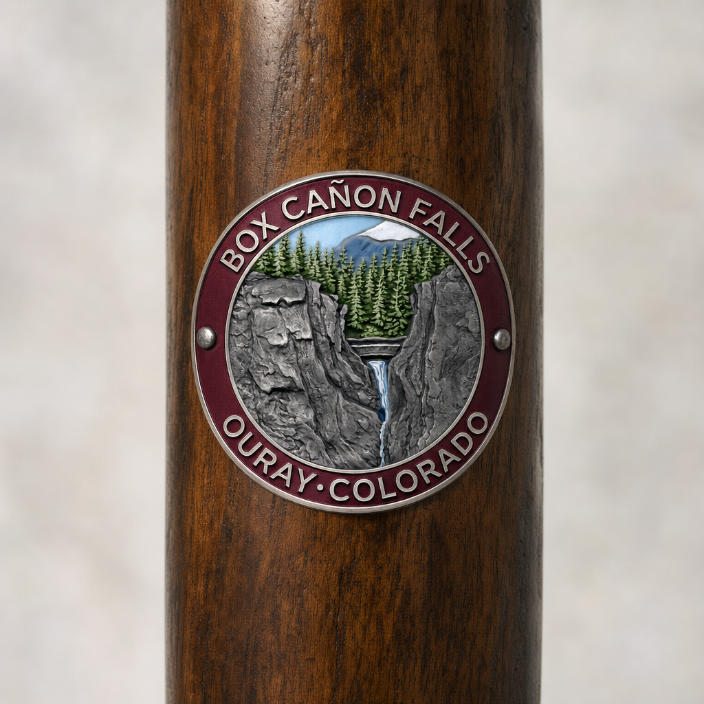 Box Canyon Falls Park hiking stick medallion installed on a wooden hiking staff