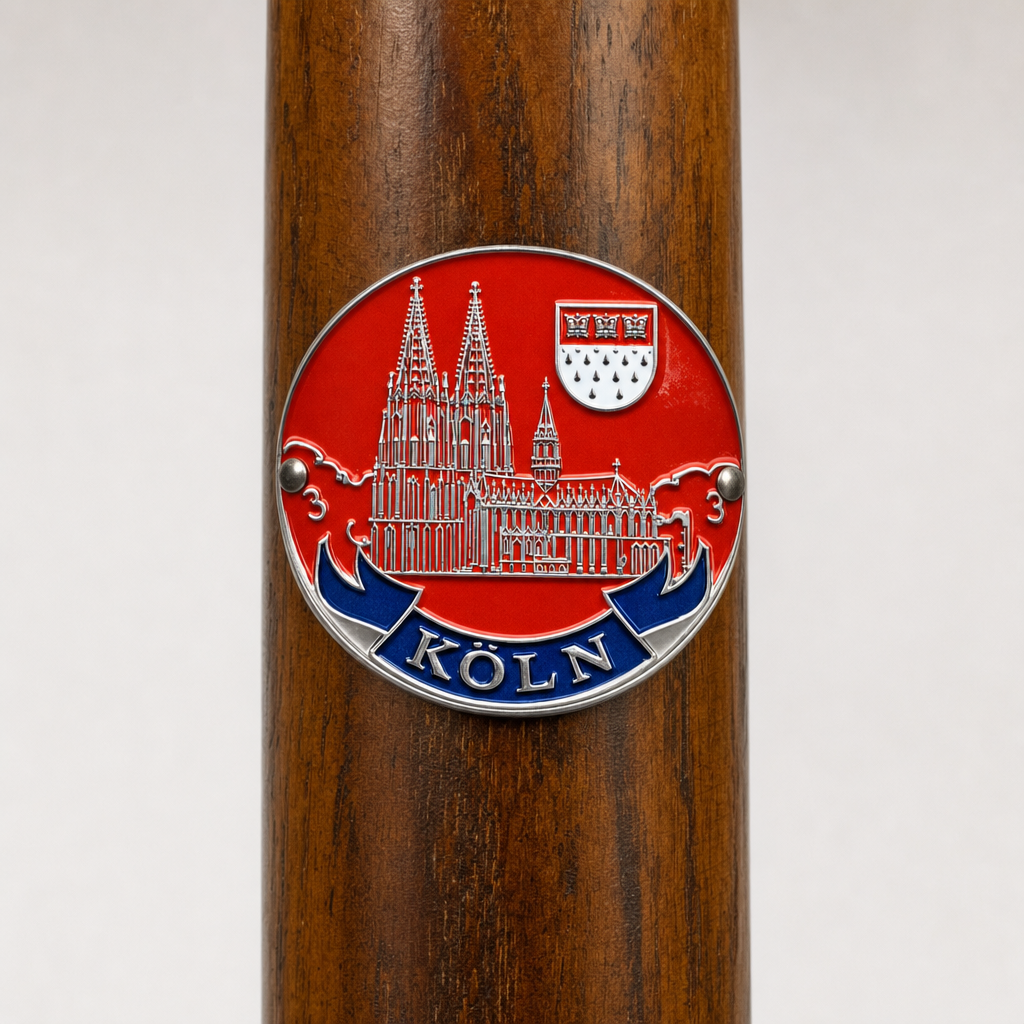 Koln hiking stick medallion installed on a wooden hiking staff