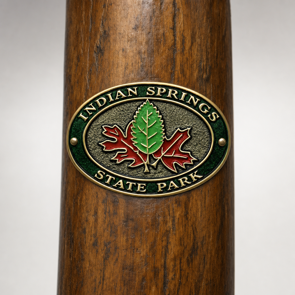 Indian Springs State Park hiking stick medallion installed on a wooden hiking staff