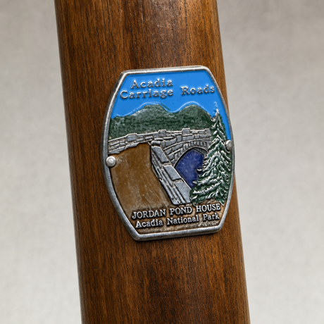 Acadia National Park Carriage Roads Trails hiking stick medallion installed on a wooden hiking staff