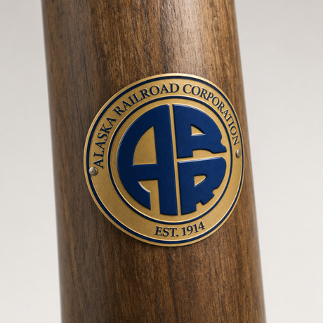 Alaska Railroad Corporation hiking stick medallion installed on a wooden hiking staff