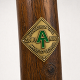 2,000 Miler hiking stick medallion installed on a wooden hiking staff