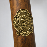 Maine Appalachian Trail hiking stick medallion installed on a wooden hiking staff