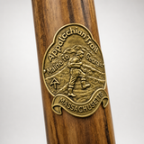 Massachusetts Appalachian Trail hiking stick medallion installed on a wooden hiking staff