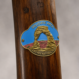 Arches National Park - Delicate Arch hiking stick medallion installed on a wooden hiking staff