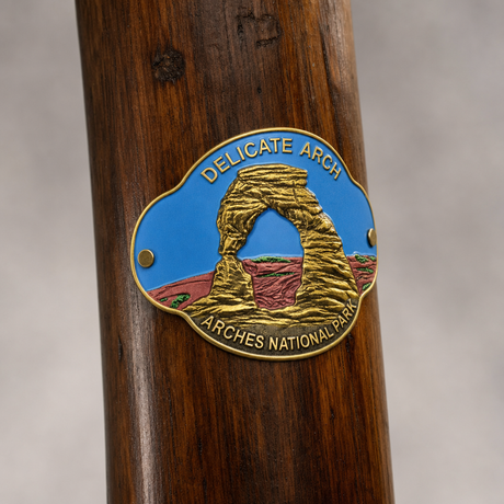 Arches National Park - Delicate Arch hiking stick medallion installed on a wooden hiking staff