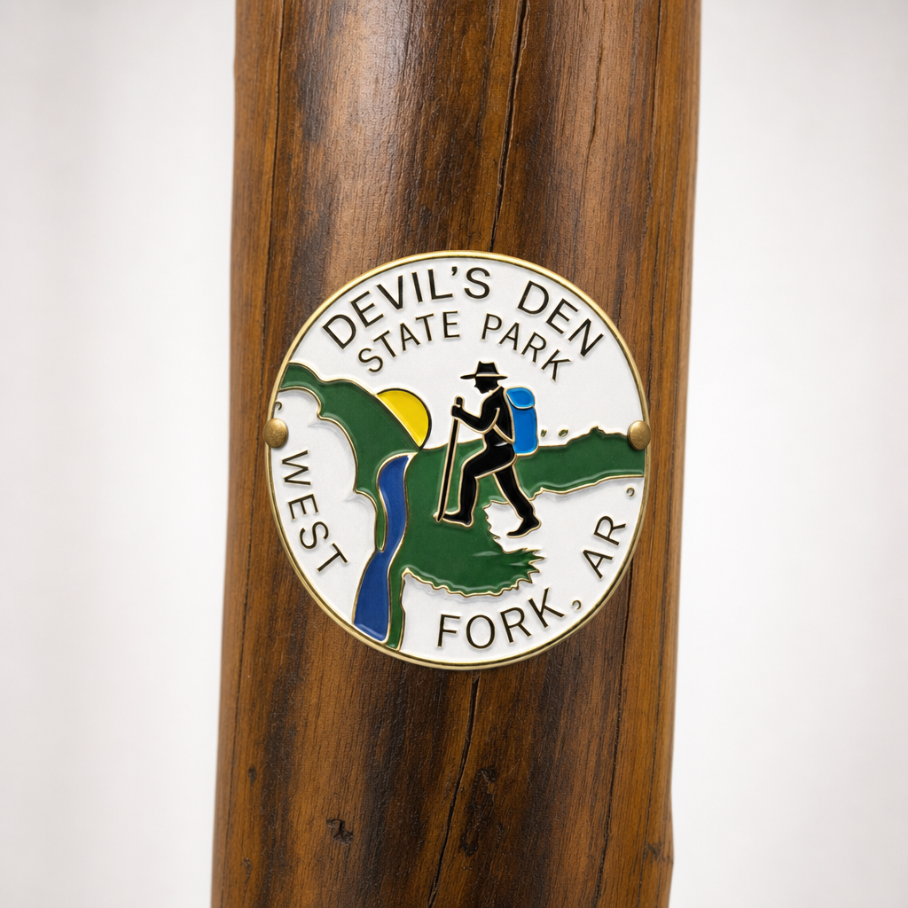 Devil's Den State Park Logo hiking stick medallion installed on a wooden hiking staff