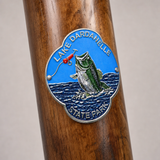 Lake Dardanelle State Park hiking stick medallion installed on a wooden hiking staff