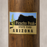 Picacho Peak State Park hiking stick medallion installed on a wooden hiking staff
