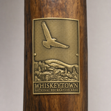 Whiskeytown National Recreation Area hiking stick medallion installed on a wooden hiking staff