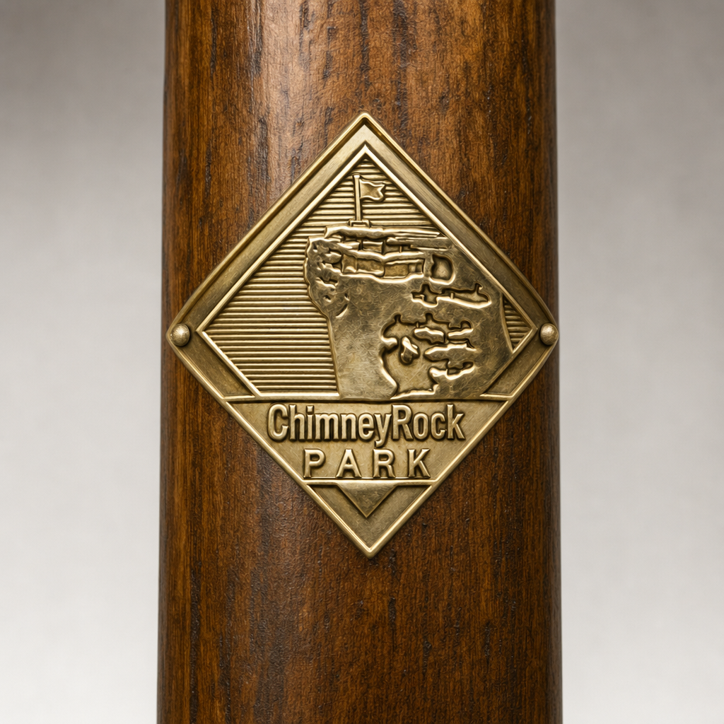 Chimney Rock State Park Logo hiking stick medallion installed on a wooden hiking staff