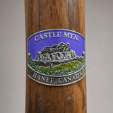 Banff Canadian National Park Castle Mountain hiking stick medallion installed on a wooden hiking staff