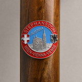 Vienna hiking stick medallion installed on a wooden hiking staff