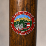 Salzburg hiking stick medallion installed on a wooden hiking staff