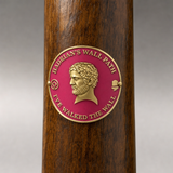 Hadrian's Wall hiking stick medallion installed on a wooden hiking staff