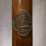 Florida Caverns State Park hiking stick medallion installed on a wooden hiking staff