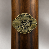 Fort Clinch State Park hiking stick medallion installed on a wooden hiking staff