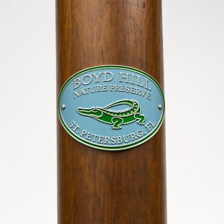 Boyd-Hill Nature Preserve hiking stick medallion installed on a wooden hiking staff