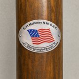 Fort McHenry National Monument hiking stick medallion installed on a wooden hiking staff