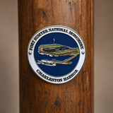 Fort Sumter hiking stick medallion installed on a wooden hiking staff