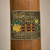 Sweetwater Creek State Park hiking stick medallion installed on a wooden hiking staff