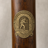 Amicalola Falls State Park - Approach Trail hiking stick medallion installed on a wooden hiking staff