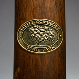 Little Ocmulgee State Park hiking stick medallion installed on a wooden hiking staff
