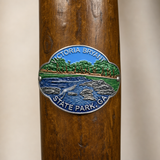 Victoria Bryant State Park hiking stick medallion installed on a wooden hiking staff