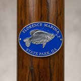 Florence Marina State Park hiking stick medallion installed on a wooden hiking staff
