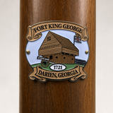 Fort King George hiking stick medallion installed on a wooden hiking staff