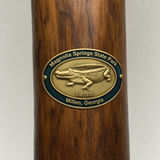 Magnolia Springs State Park hiking stick medallion installed on a wooden hiking staff