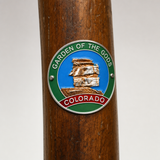 Garden of the Gods City Park View hiking stick medallion installed on a wooden hiking staff