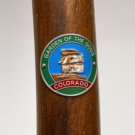 Garden of the Gods City Park View hiking stick medallion installed on a wooden hiking staff